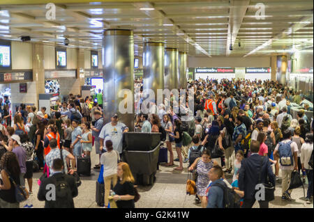 Thousands pack Penn Station in New York to get out of the city for the Memorial Day weekend on Friday, May 27, 2016. Every Friday during the summer the train, consisting of double-decker cars pulled by a powerful dual-mode locomotive, will run express to Westhampton on Long Island making the 76 mile trip in 94 minutes. From Westhampton it will continue to points east arriving at the tip of the island, Montauk. On Sundays the train will reverse and return to Penn Station. The train is the only named run on the railroad. The trip from Penn Station to the Montauk terminal is 117 miles making the Stock Photo