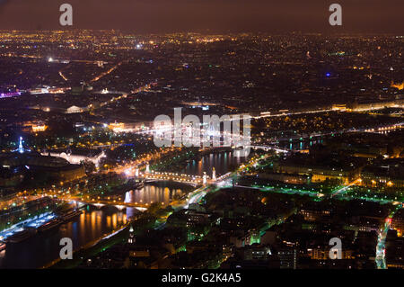 Aerial Night view of Paris City and Seine river shot on the top of Eiffel Tower Stock Photo