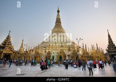 Believers and tourists at Shwedagon Paya, Yangon, Myanmar Stock Photo