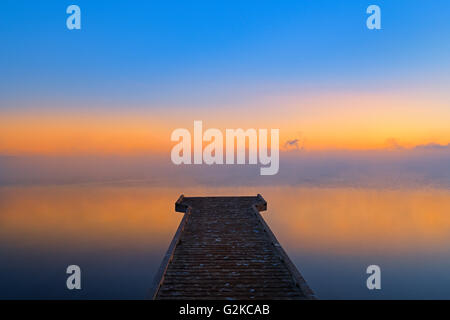 Dock in fog at sunrise on Sturgeon Lake Williamson Provincial Park Alberta Canada Stock Photo