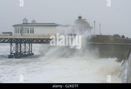 Waves hit the pier at Cromer beach, in Norfolk. Stock Photo