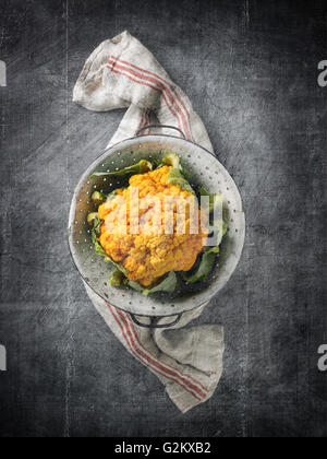 Yellow Cauliflower in Colander with Linen Towel on Stone Grey Surface Stock Photo