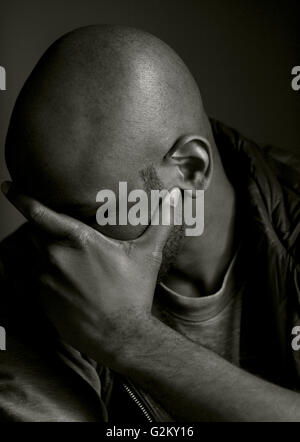 Man with Head in Hand Stock Photo