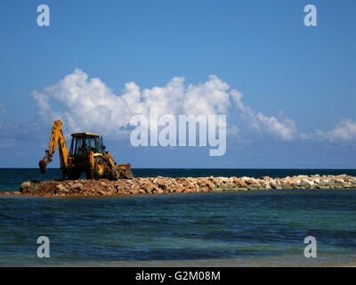 Work being carried out on a beach in order to protect certain beach area against tidal flooding, Decameron Hotel Stock Photo