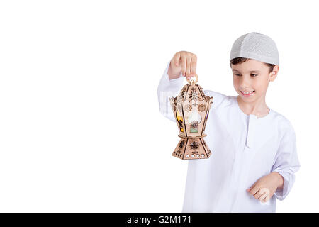 Happy young kid playing with Ramadan lantern Stock Photo