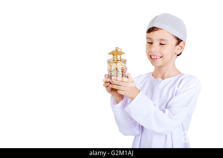 Ramadan Kareem - Happy young kid playing with Ramadan lantern - Isolated on white background Stock Photo