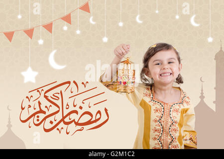 Greeting Card : Ramadan Kareem - Muslim Holy Month Ramadan is generous - Happy young girl playing with Ramadan lantern Stock Photo