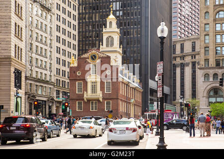 BOSTON, MASSACHUSETTS - MAY 14, 2016: Street view of historic Old State House along Boston's Freedom Trail, with cars visible.