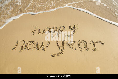 happy new year written in the sand Stock Photo