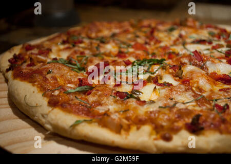 Spicy Sicilian chicken pizza made in a traditional wood oven. Stock Photo