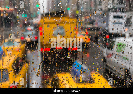 Looking through raindrops streaking across a window onto a traffic jam in New York Stock Photo