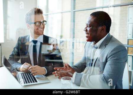 Employees discussing data at workplace Stock Photo