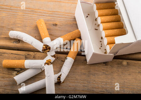 Quit Smoking - Broken unsmoked cigarettes next to a plain white pack Stock Photo