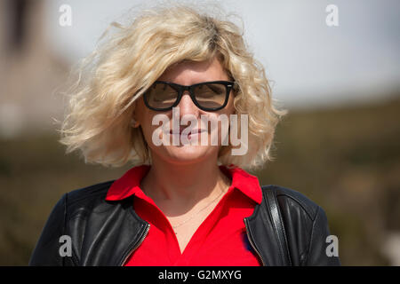 Stunning woman in sunglasses is smiling Stock Photo