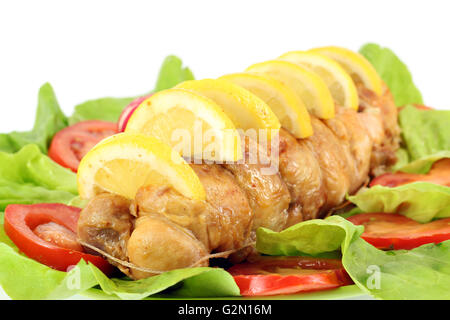 rolled chicken meat with lemon and salad Stock Photo