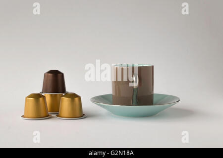 Espresso cup and saucer with coffee pods on white background Stock Photo