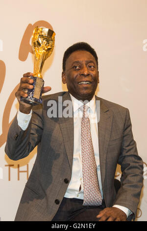 London, UK. 1 June 2016. Pele holds his copy of the Jules Rimet Trophy at a photocall. Brazilian footballing legend attends the press preview of Pele - The Collection, a sale of Pele's personal items run by Julien's Auctions at Mall Galleries in London. Highlights include Pele's Jules Rimet Trophy; 1958, 1962 and 1970 World Cup Medals; Santos FC game worn jerseys and boots; awards received while playing with Santos FC; his 1977 New York Cosmos NASL championship ring; FIFA Player of the Century Award; L'Equipe Athlete of the Century Award; 2007 FIFA President's Award and the torch used by Pele Stock Photo