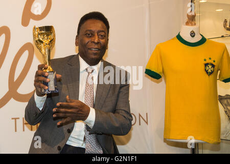 London, UK. 1 June 2016. Pele holds his copy of the Jules Rimet Trophy at a photocall. Brazilian footballing legend attends the press preview of Pele - The Collection, a sale of Pele's personal items run by Julien's Auctions at Mall Galleries in London. Highlights include Pele's Jules Rimet Trophy; 1958, 1962 and 1970 World Cup Medals; Santos FC game worn jerseys and boots; awards received while playing with Santos FC; his 1977 New York Cosmos NASL championship ring; FIFA Player of the Century Award; L'Equipe Athlete of the Century Award; 2007 FIFA President's Award and the torch used by Pele Stock Photo