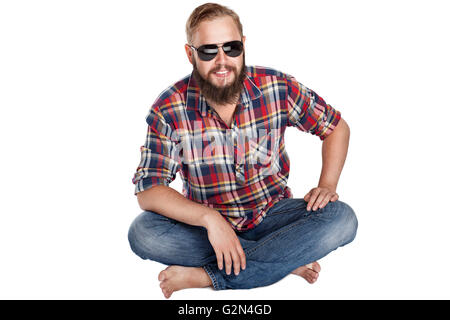 young bearded lumberjack sitting in sunglasses Stock Photo
