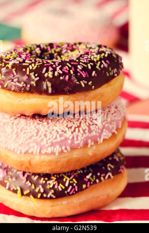 closeup of a pile of appetizing donuts with different frostings Stock Photo