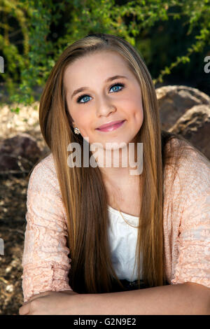 Portrait of a beautiful, blue-eyed, teenage girl with long blond hair. Stock Photo