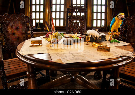 Pirate's accessories on a table in pirate ship Stock Photo