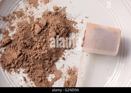 Powdered meal replacement shake powder on plate with a scoop Stock Photo