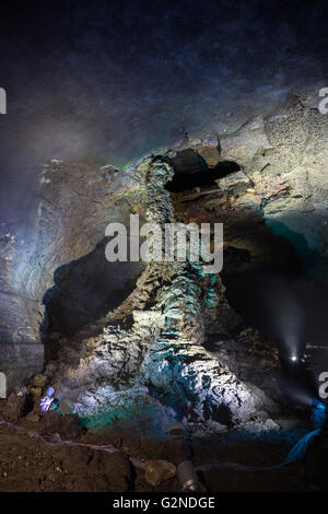 Lit lava column at the dark and empty Manjanggul Lava Tube Cave on Jeju Island in South Korea. Stock Photo