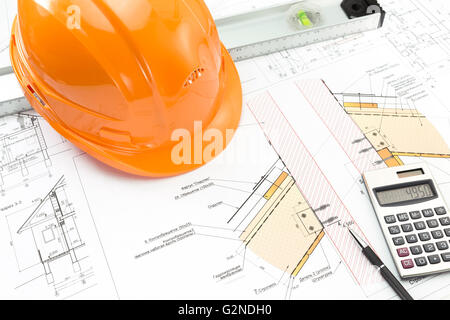 Construction plans with helmet and work tools on blueprint Stock Photo