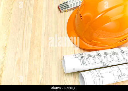 rolls of blueprints with wooden ruler and safety helmet Stock Photo - Alamy