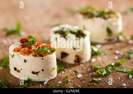 Delicious appetizers with cheese and various ingredients on wooden background Stock Photo