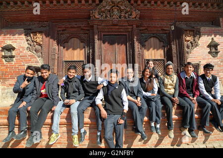 Nepalese students posing in front of a temple at Durbar Square in Patan, Nepal Stock Photo