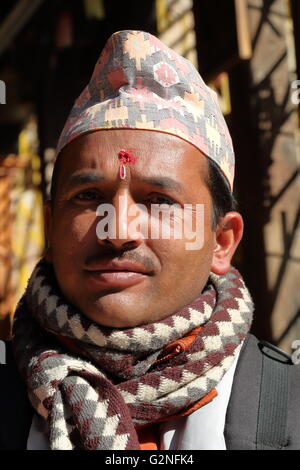 Portrait of a Nepalese man wearing Dhaka Topi (traditional Nepalese hat) at Ichangu Narayan Temple, Bodhnath, Nepal Stock Photo