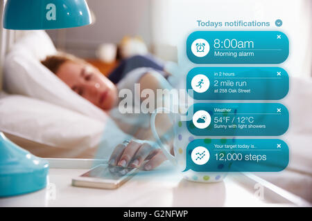 Woman In Bed Reading Health Notifications On Phone Stock Photo