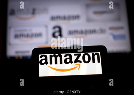Amazon online retailer logos are pictured on phone and laptop screens. Stock Photo