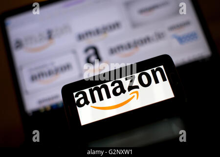 Amazon online retailer logos are pictured on phone and laptop screens. Stock Photo