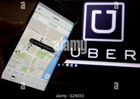 Uber taxi cab app is pictured in London on 8 May 2019. Stock Photo