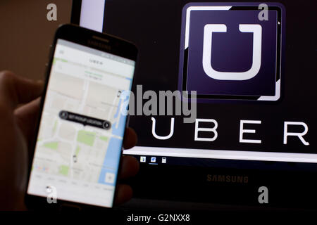 Uber taxi cab app is pictured in London on 8 May 2019. Stock Photo