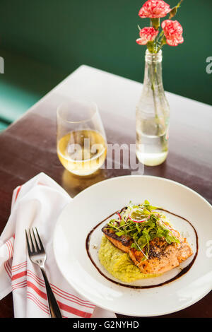 maple-miso glazed salmon and a glass of chardonnay wine, Mouthful Eatery, Thousand Oaks, California Stock Photo