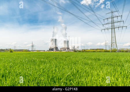 Nuclear power plant with green field and big blue clouds Stock Photo
