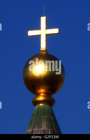 The copper ball and cross from atop the Basilica di Santa Maria del Fiore, more commonly called the 'Duomo'. Florence, Italy. Started in 1296 based on Arnolfo di Cambio's design, but was not complete until 1436 when Filippo Brunelleschi engineered the dome. One of Italy's largest churches. The dome itself is octagonal, and uses a double shell design, made of sandstone and marble. Stock Photo