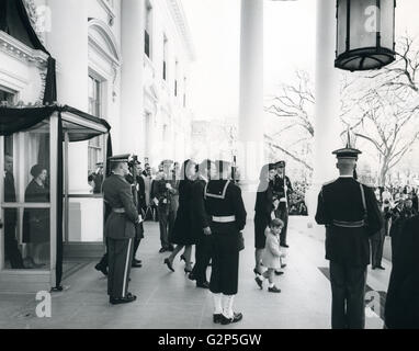 The Kennedy family leaves the White House to attend the brief service at the U.S. Capitol. President and Mrs. Johnson follow. Abbie Rowe photographer. Stock Photo