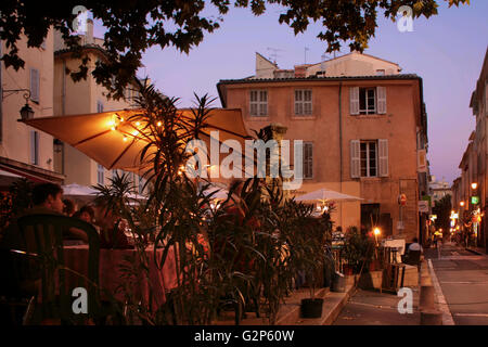 Place des Tanneurs and Rue de la Couronne, Aix-en-Provence, France, on a summer's evening with restaurant tables on the pavement Stock Photo