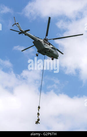 Military special forces during operation with a helicopter Stock Photo