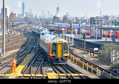 Clapham Junction train station urban landscape train tracks & distant London skyline with South West Trains passenger service returns to depot at  UK Stock Photo