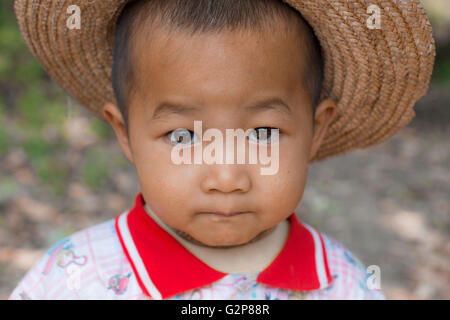 Burmese child playing in fields. Village near Mandalay, Myanmar, Burma, South Asia, Asia Stock Photo