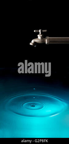 water faucet dripping making ripples on water Stock Photo