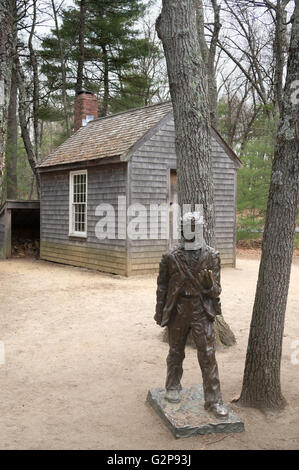 A bronze statue of Henry David Thoreau with a reconstruction of his cabin, Walden Pond, Concord, Massachusetts, USA Stock Photo