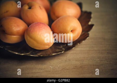 Fresh Apricots on decorative metal plate Stock Photo