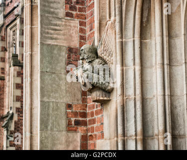 Stone angel figure holding Red Hand of Ulster Crest. Lanyon building. Queens University. Belfast, Northern Ireland, UK. Europe Stock Photo